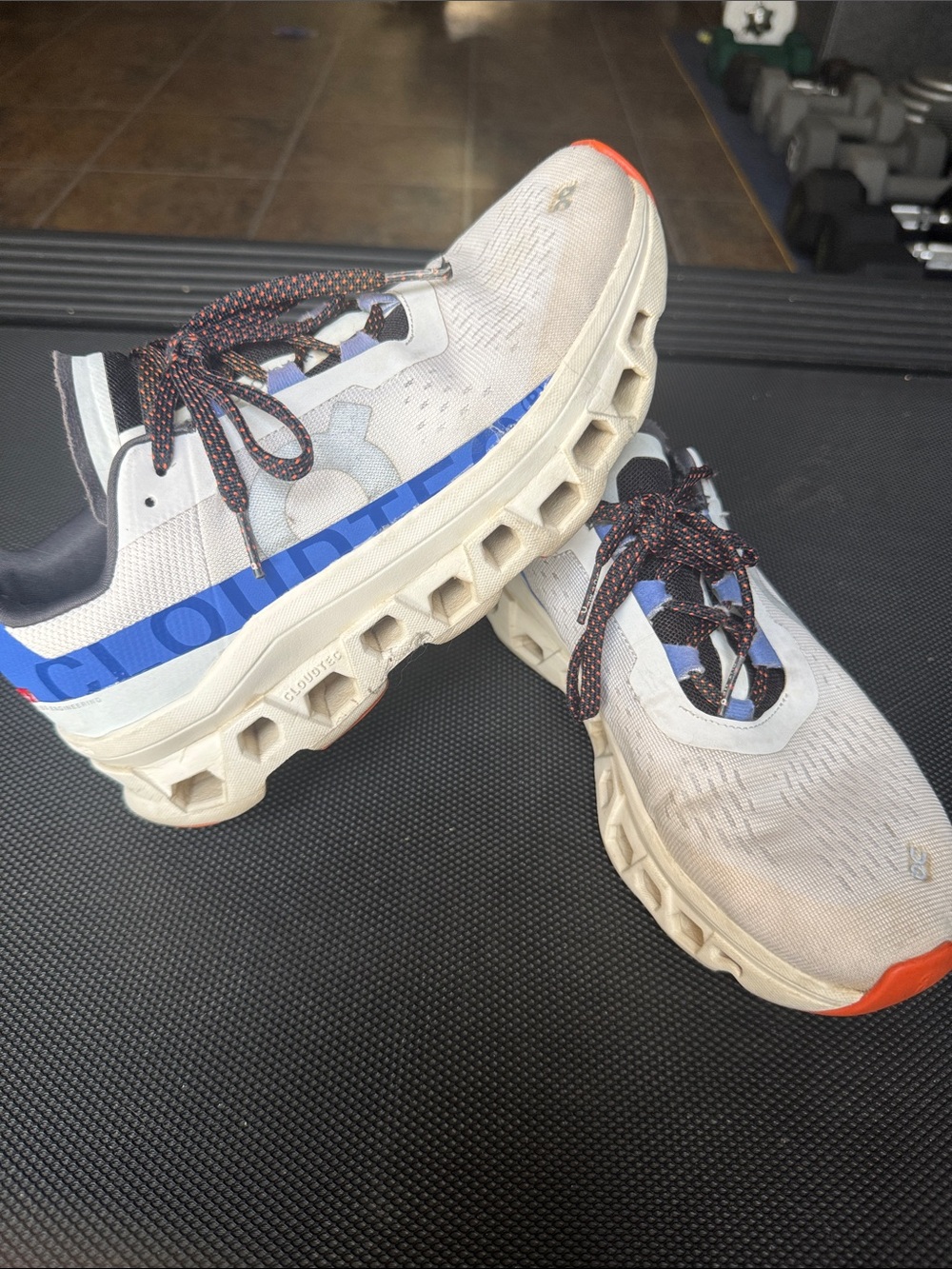 On Running White and Blue Mesh Trainers with Orange Accents
